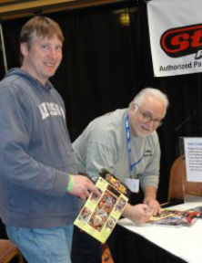 John Trudeau autorgraphs for a fan.